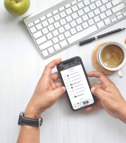 Man checking smart lock app at desk of home office