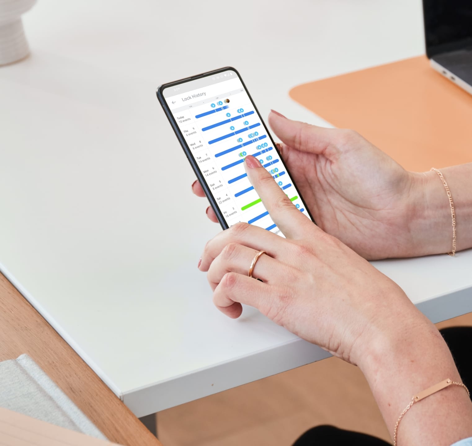 Woman checking her Nest x Yale lock history on mobile App